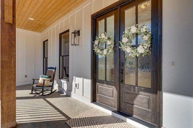 entrance to property with covered porch and french doors