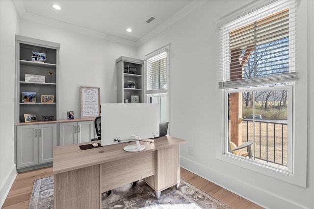 office space featuring light wood finished floors, baseboards, and ornamental molding