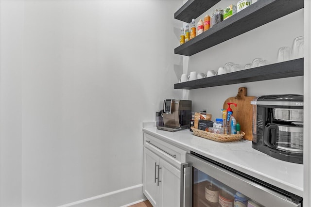 bar with baseboards and wine cooler