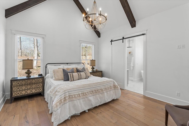 bedroom featuring baseboards, a barn door, wood-type flooring, and beam ceiling