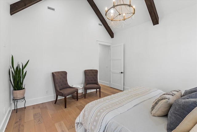 bedroom with visible vents, baseboards, light wood-style floors, and a chandelier