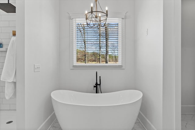 bathroom with a tile shower, a soaking tub, marble finish floor, and baseboards