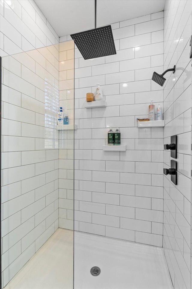 full bath with a tile shower