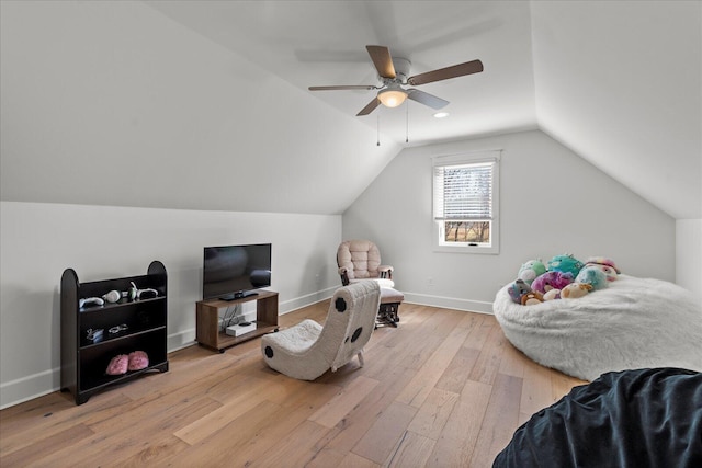 bedroom featuring a ceiling fan, lofted ceiling, light wood-style floors, and baseboards