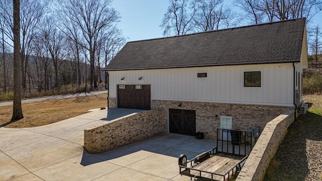 garage featuring central AC unit and driveway