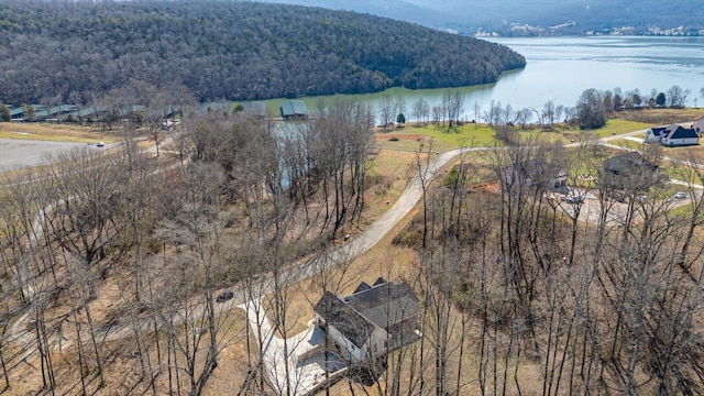 aerial view with a wooded view and a water view