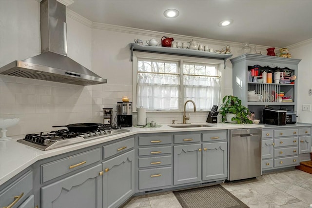 kitchen featuring a sink, appliances with stainless steel finishes, wall chimney exhaust hood, and gray cabinets