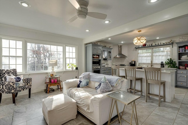 living room with recessed lighting, baseboards, ceiling fan, and crown molding