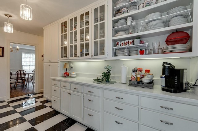 kitchen with tile patterned floors, white cabinets, glass insert cabinets, and pendant lighting