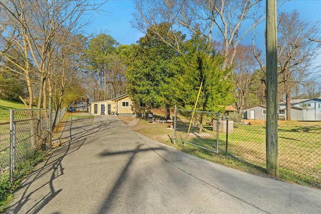 view of street featuring a gated entry and driveway