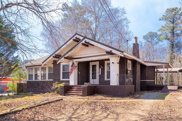 bungalow with a porch and a chimney