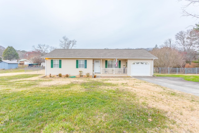 single story home featuring aphalt driveway, a porch, fence, an attached garage, and a front yard