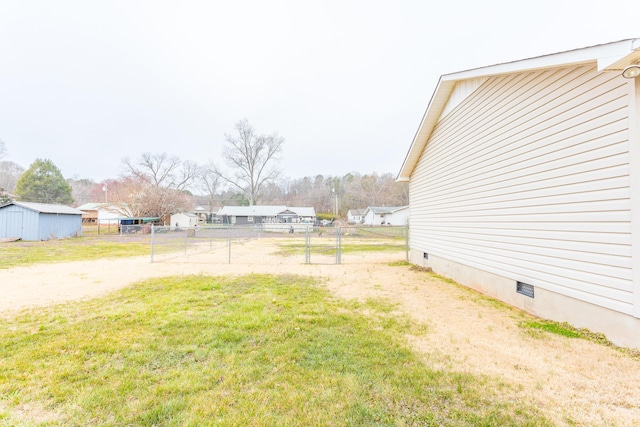 view of yard featuring an outdoor structure and fence