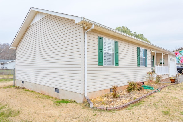 view of home's exterior with a yard and crawl space