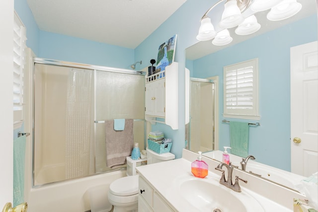 full bath featuring vanity, toilet, and shower / bath combination with glass door