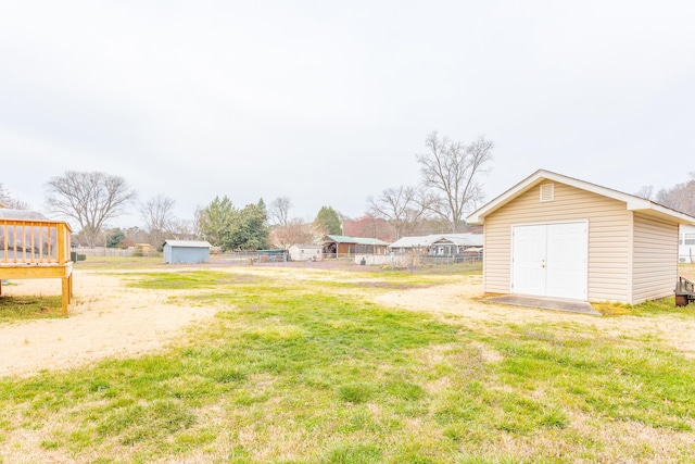 view of yard with a storage unit, an outdoor structure, and fence