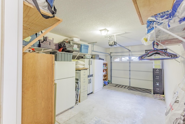 garage with a garage door opener and freestanding refrigerator