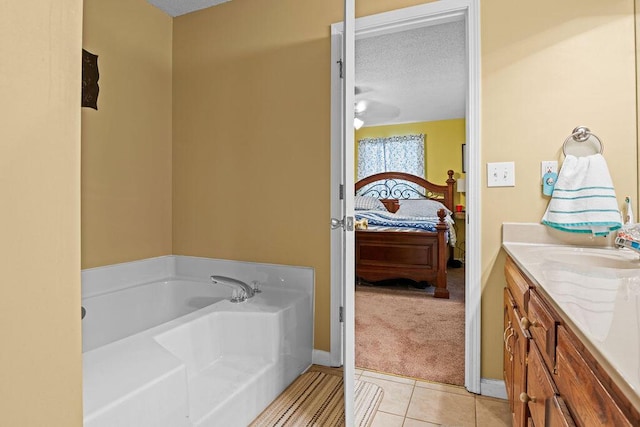 full bathroom featuring tile patterned floors, ensuite bathroom, a textured ceiling, a bath, and vanity