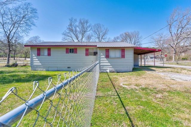 view of front of property with fence, crawl space, metal roof, a carport, and driveway