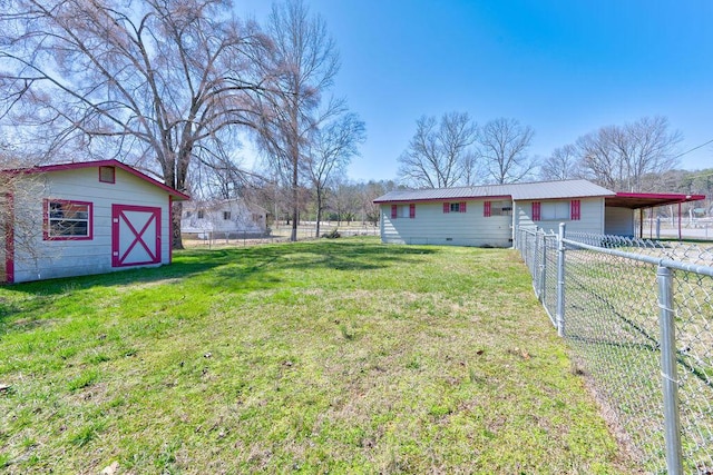 view of yard with an outbuilding and fence