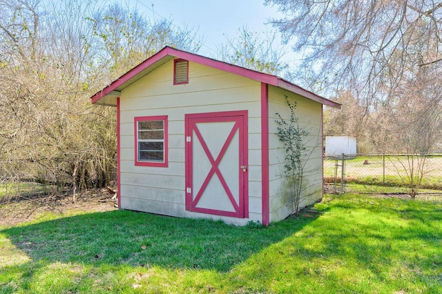 view of shed featuring fence