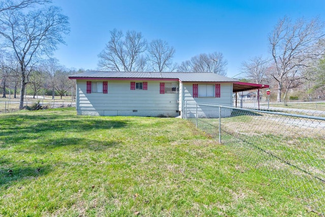 view of front of property with fence, metal roof, a front yard, crawl space, and an attached carport