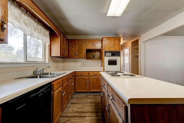 kitchen featuring a sink, open shelves, dark wood-style floors, white appliances, and light countertops