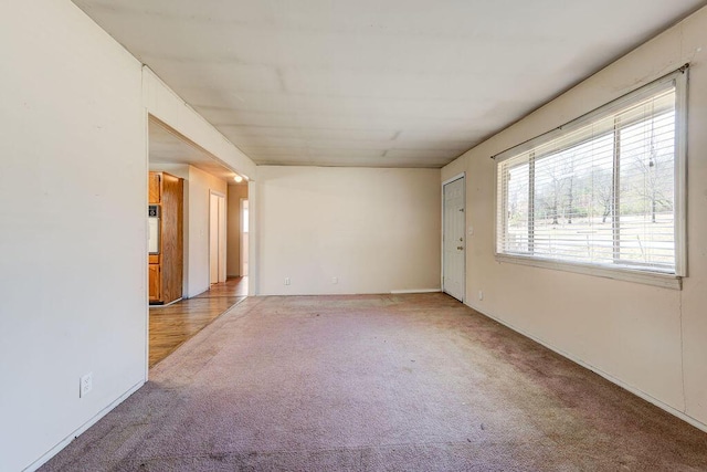 unfurnished room featuring light colored carpet