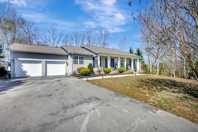 ranch-style home featuring aphalt driveway, a porch, and an attached garage