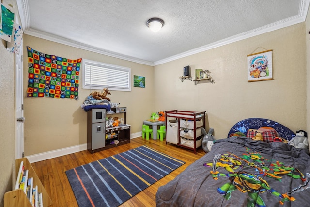 bedroom with a textured ceiling, crown molding, baseboards, and hardwood / wood-style floors