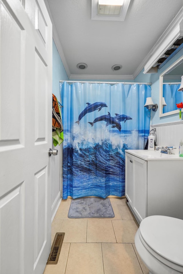 bathroom featuring visible vents, toilet, crown molding, and tile patterned flooring