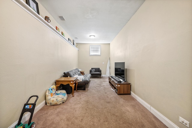 living area with visible vents, baseboards, and carpet flooring