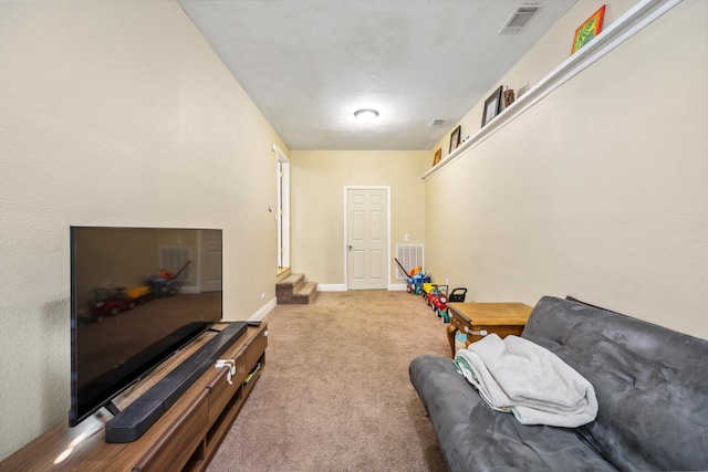 living area featuring visible vents, carpet floors, baseboards, and stairs