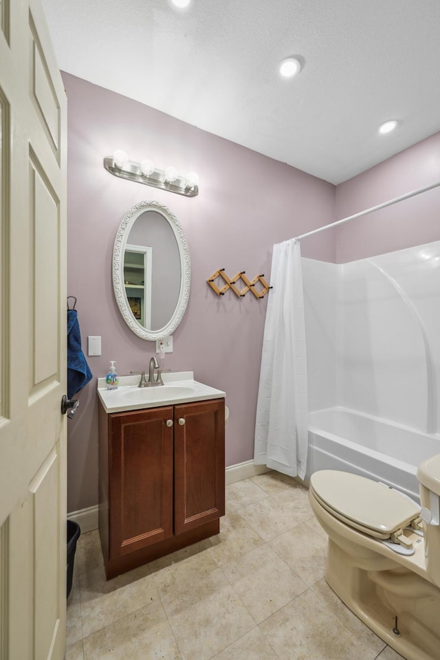 bathroom with baseboards, shower / tub combo, toilet, and vanity