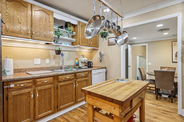 kitchen featuring a sink, crown molding, white dishwasher, and light wood-type flooring