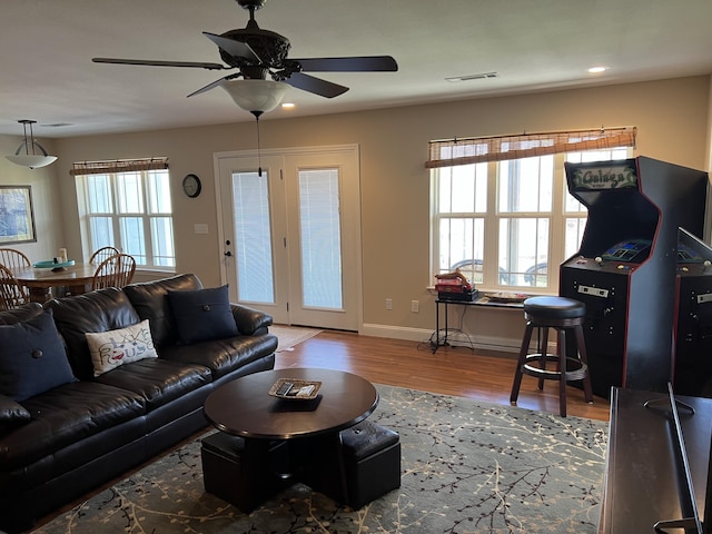 living area featuring visible vents, a ceiling fan, wood finished floors, recessed lighting, and baseboards