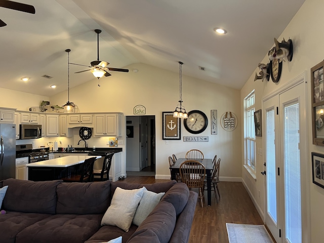 living area featuring dark wood finished floors, visible vents, a ceiling fan, and baseboards