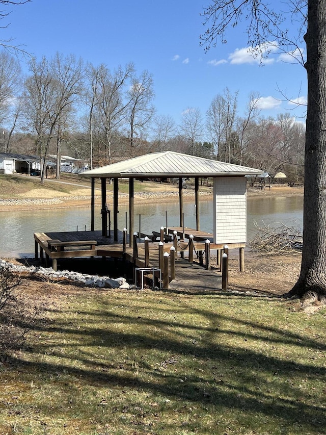 dock area featuring a lawn and a water view