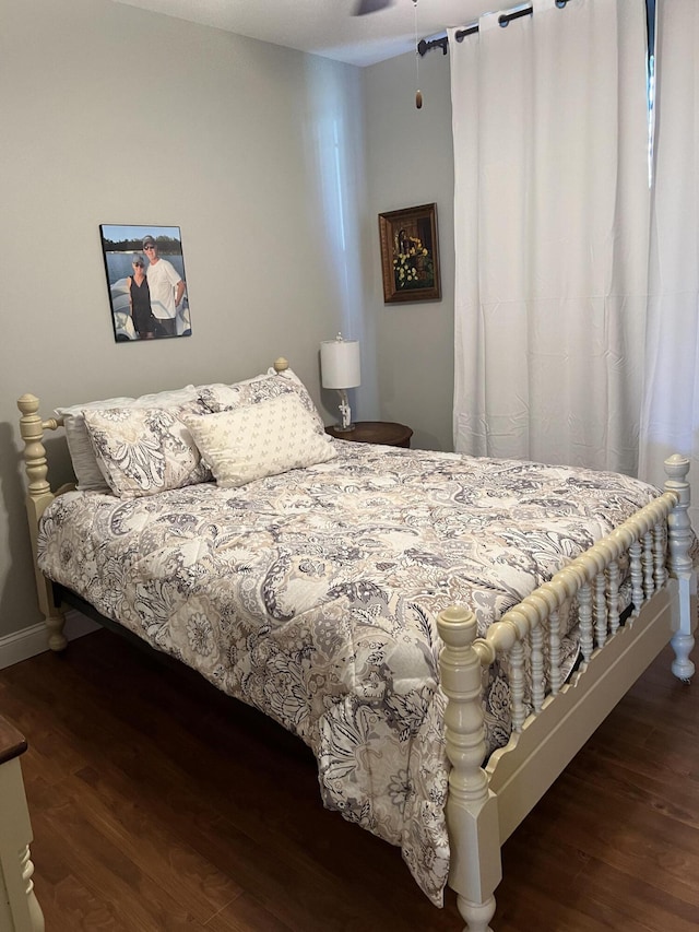 bedroom featuring wood finished floors and baseboards