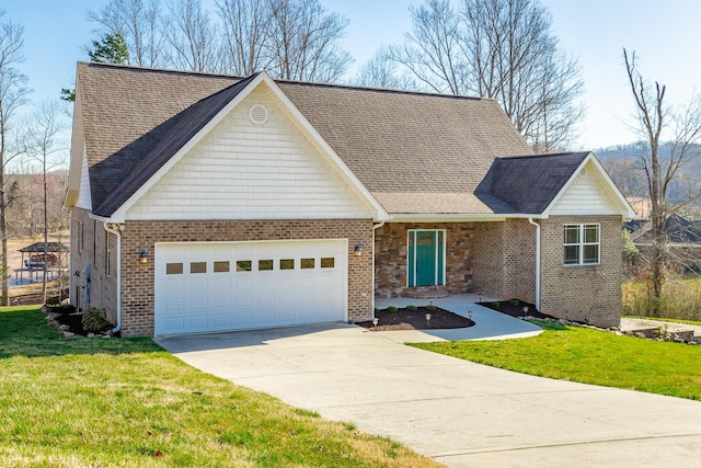 view of front facade featuring brick siding, driveway, an attached garage, and a front yard