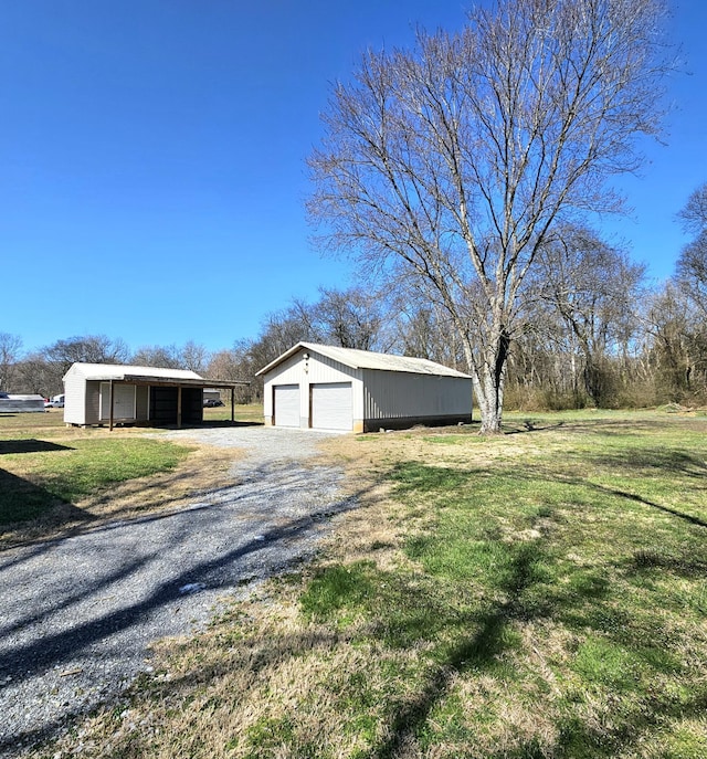 view of yard featuring an outbuilding and a detached garage