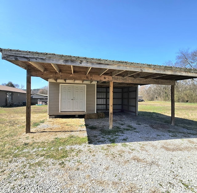 view of outdoor structure featuring an outbuilding and a carport