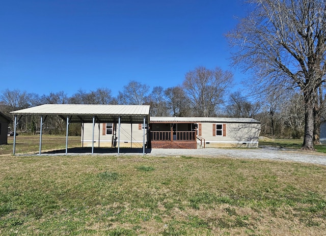 view of front of property with a detached carport, driveway, a front lawn, crawl space, and metal roof