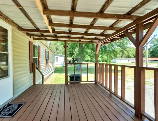 wooden terrace featuring a yard