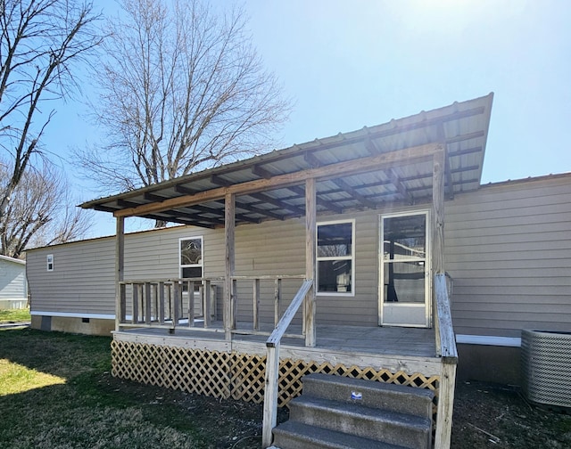 exterior space featuring central air condition unit and a lawn