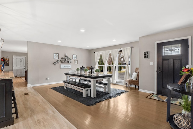 dining space featuring recessed lighting, baseboards, and light wood finished floors