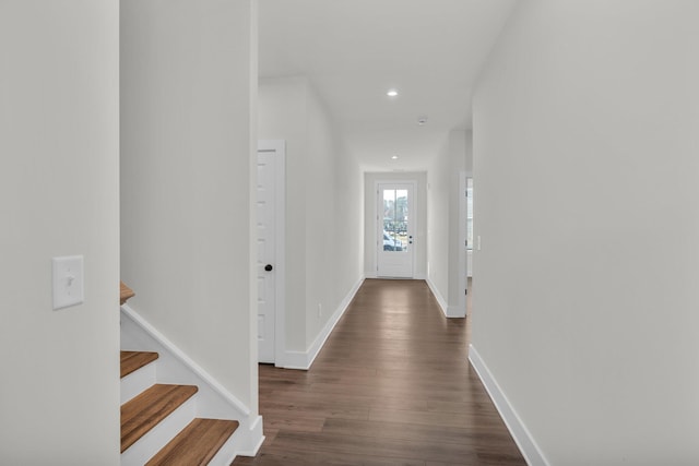 hallway with dark wood-style floors, stairway, recessed lighting, and baseboards