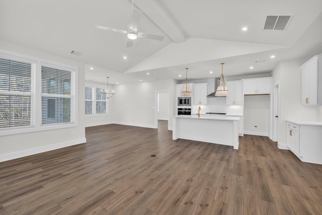 unfurnished living room featuring visible vents, dark wood finished floors, beamed ceiling, ceiling fan with notable chandelier, and recessed lighting