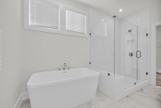 bathroom with a shower stall, a freestanding tub, baseboards, and marble finish floor