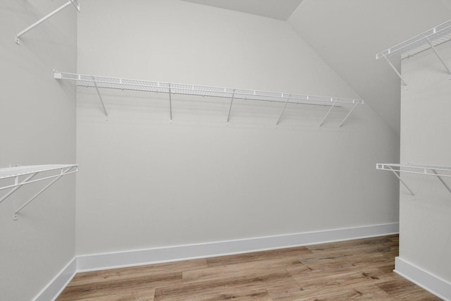 walk in closet featuring lofted ceiling and light wood-style flooring